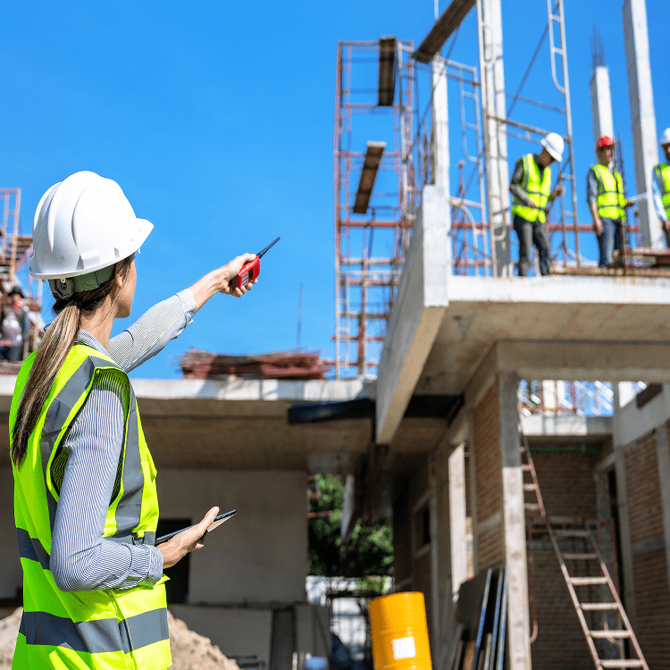 Construction site with workers and architect planning.