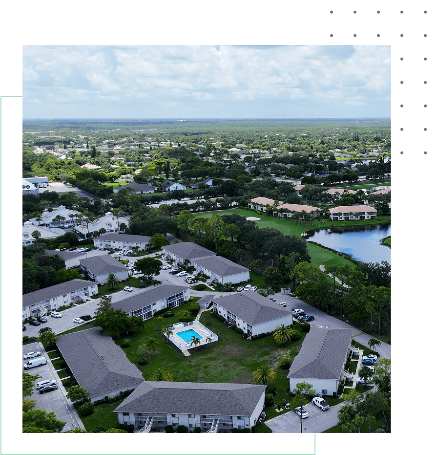 Aerial view of suburban neighborhood with pool.